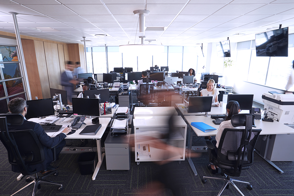 Interior Of Busy Modern Open Plan Office With Staff