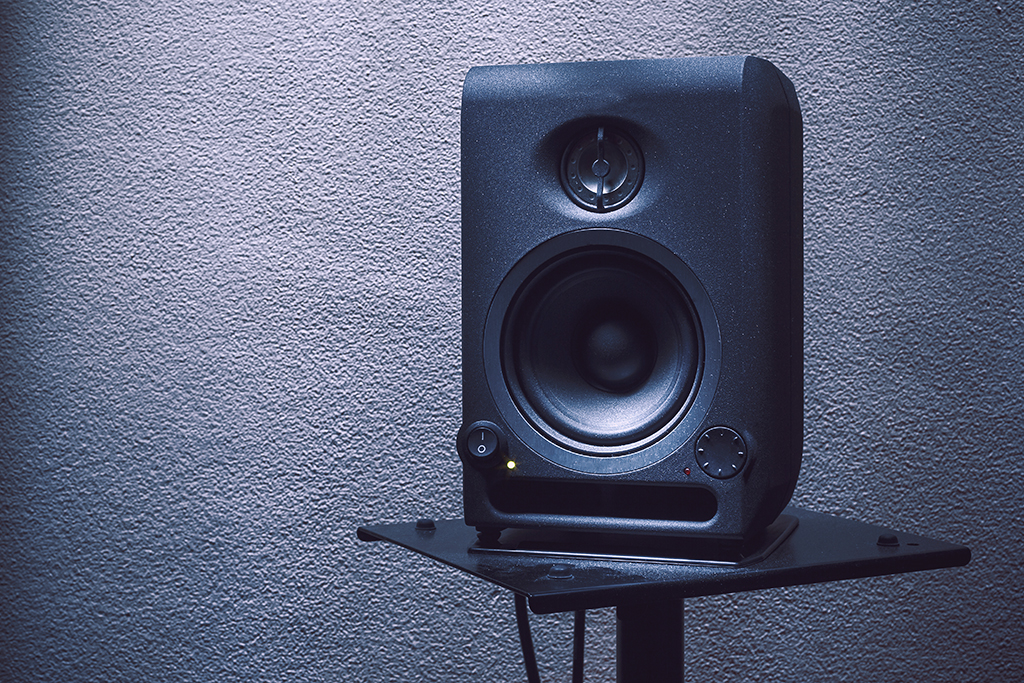 Modern studio monitor on stand