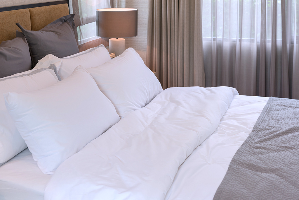 hotel room bed with pillows, interior design concept