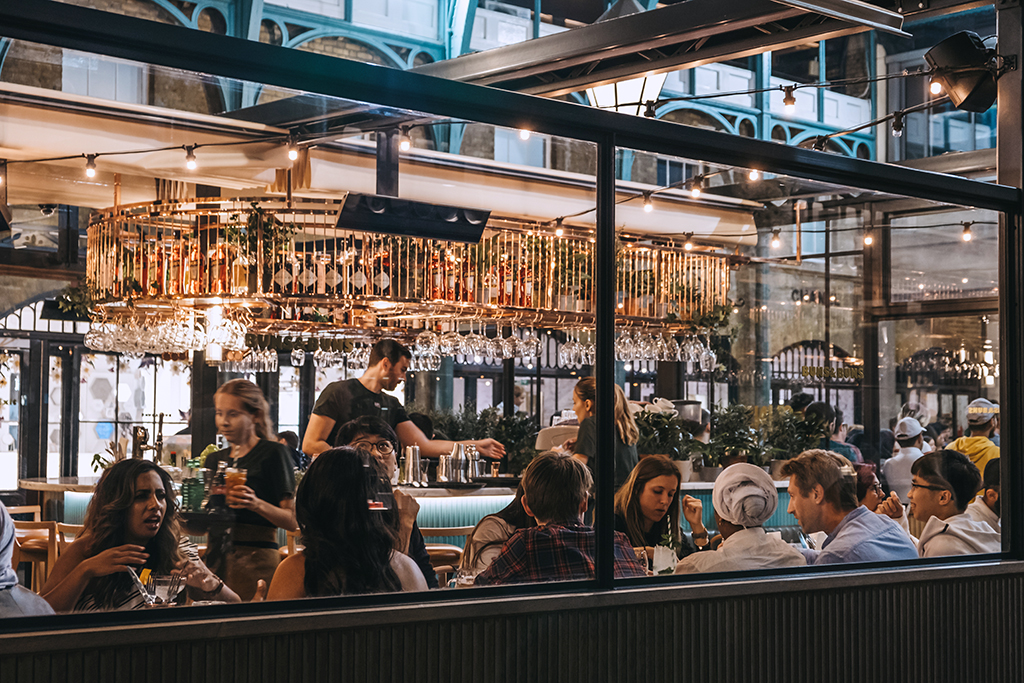 View through the window of staff and customers inside a restaurant